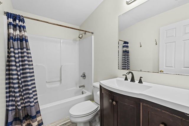 bathroom with toilet, vanity, and shower / tub combo