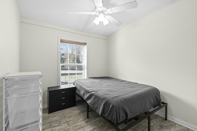 bedroom featuring baseboards, a ceiling fan, and light wood finished floors