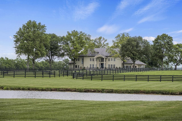 view of community featuring a lawn and fence