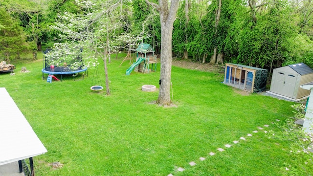 212 Williamsburg Ct, Danville, KY 40422 - view of yard with a playground, an outbuilding, a trampoline, and a storage unit