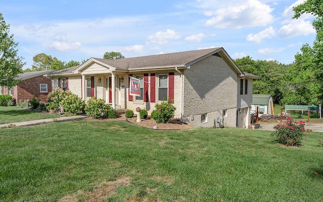 ranch-style home with brick siding and a front yard