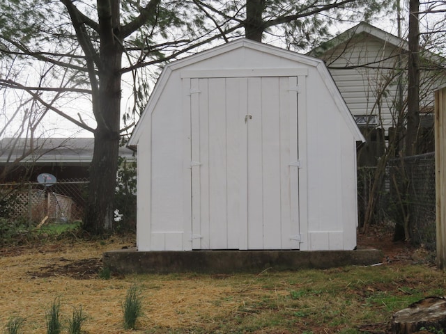 view of shed featuring fence