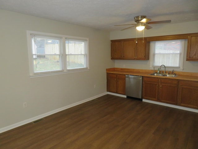 kitchen featuring dishwasher, brown cabinets, visible vents, and a sink