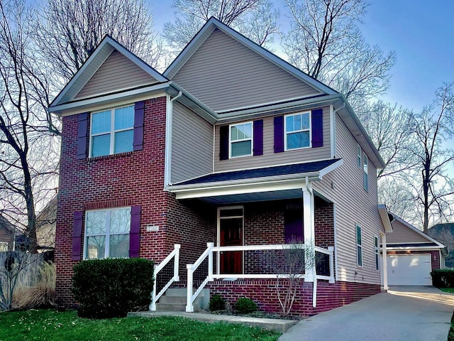 traditional-style house with an outbuilding, a garage, a porch, and brick siding