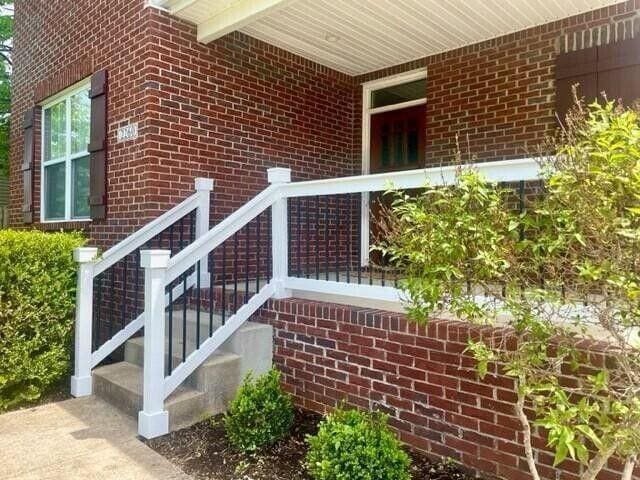 property entrance featuring brick siding