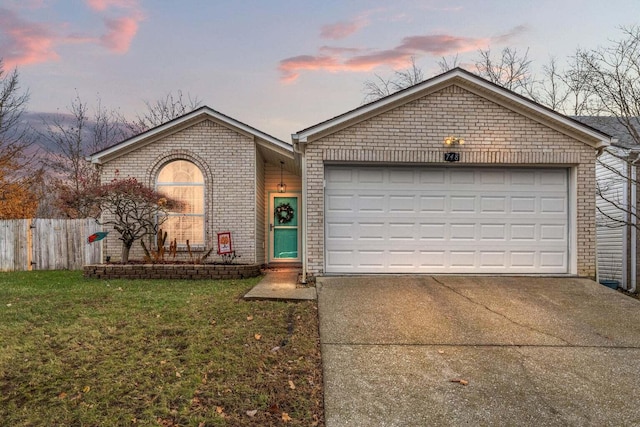 view of front of property featuring brick siding, a front lawn, fence, concrete driveway, and an attached garage