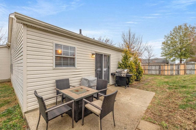 view of patio / terrace with outdoor dining space, area for grilling, and fence