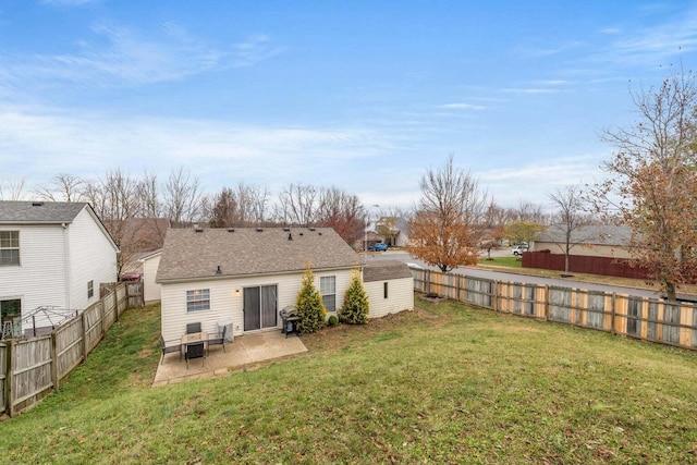 back of property featuring a yard, a patio, and a fenced backyard