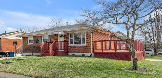view of front of home with brick siding and a front yard