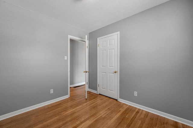 unfurnished bedroom featuring baseboards and light wood-style floors
