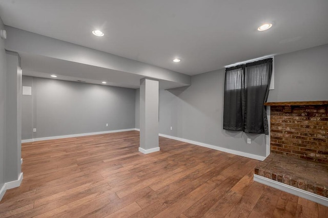 finished basement featuring hardwood / wood-style flooring, recessed lighting, and baseboards