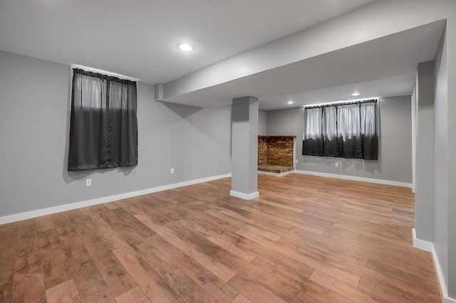 finished below grade area featuring recessed lighting, baseboards, and wood-type flooring