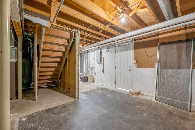 unfinished below grade area with stairway and electric panel