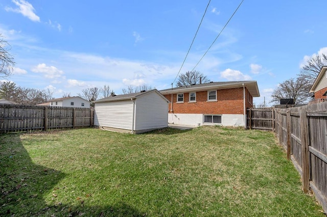 back of house with a lawn, a fenced backyard, a storage shed, an outdoor structure, and brick siding