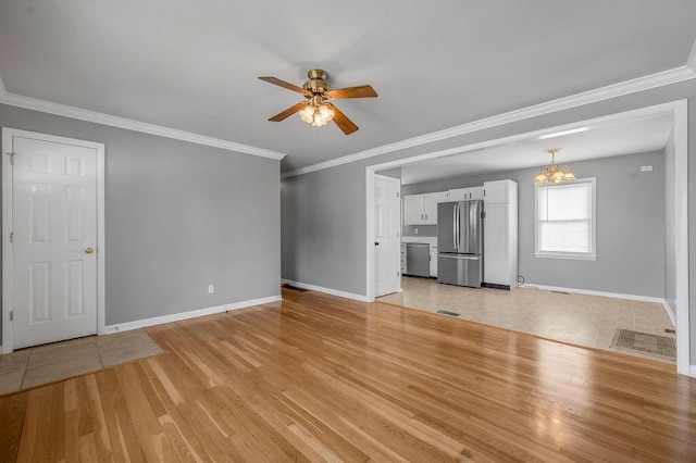 unfurnished living room with ceiling fan with notable chandelier, light wood-style flooring, baseboards, and ornamental molding