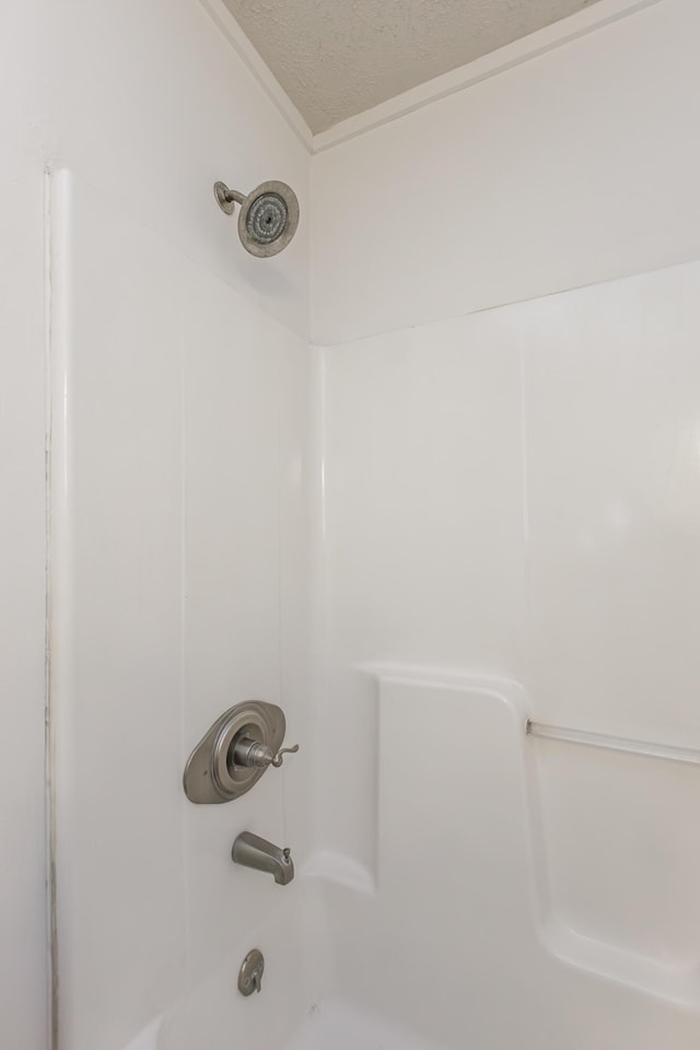 416 Ash St, Lexington, KY 40508 - room details with bathtub / shower combination and a textured ceiling