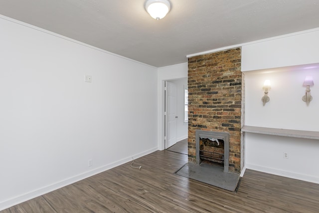 416 Ash St, Lexington, KY 40508 - unfurnished living room featuring baseboards, a brick fireplace, wood finished floors, and ornamental molding