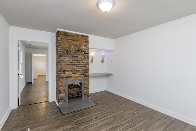 416 Ash St, Lexington, KY 40508 - unfurnished living room featuring dark wood finished floors, crown molding, a brick fireplace, and baseboards