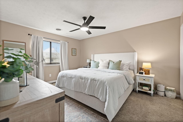 carpeted bedroom with baseboards, ceiling fan, and visible vents