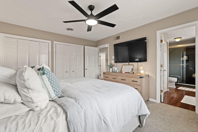 bedroom with baseboards, multiple closets, visible vents, and carpet