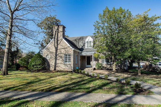 cape cod-style house featuring a front lawn