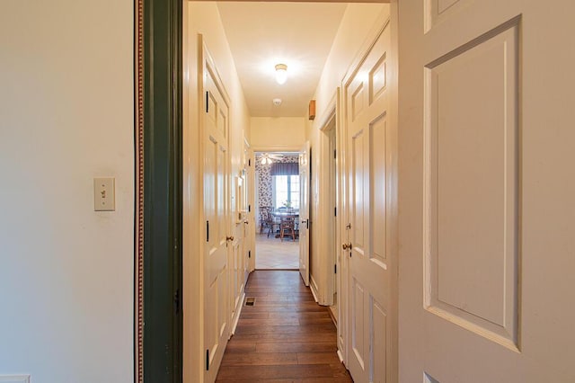 corridor featuring dark wood-type flooring