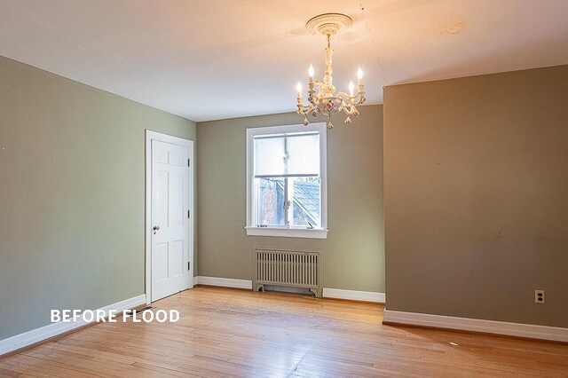 empty room with baseboards, radiator heating unit, and hardwood / wood-style floors