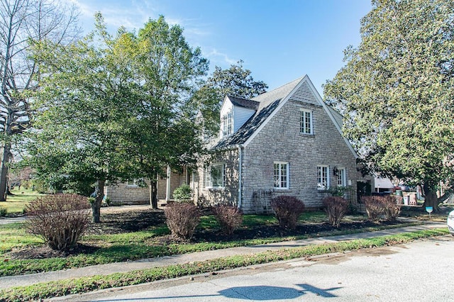 view of side of property featuring stone siding
