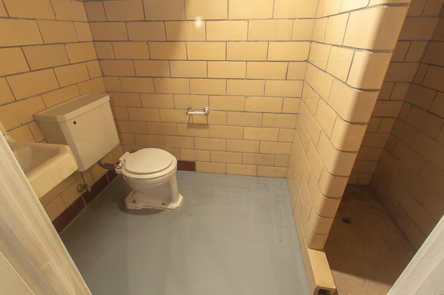 full bath with tile walls, a shower, and toilet