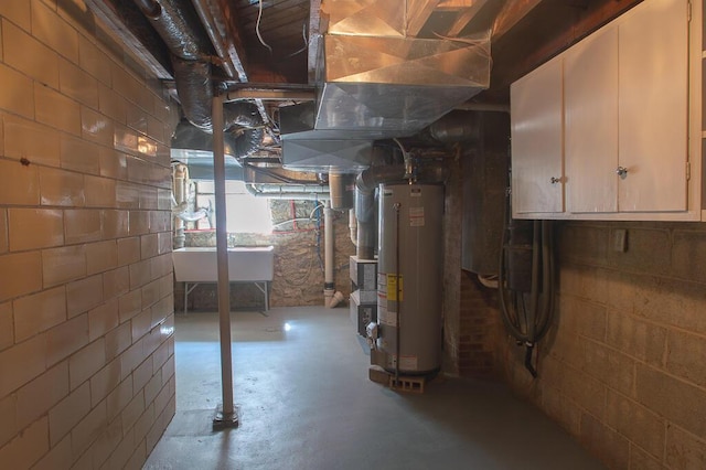 basement with a sink and gas water heater