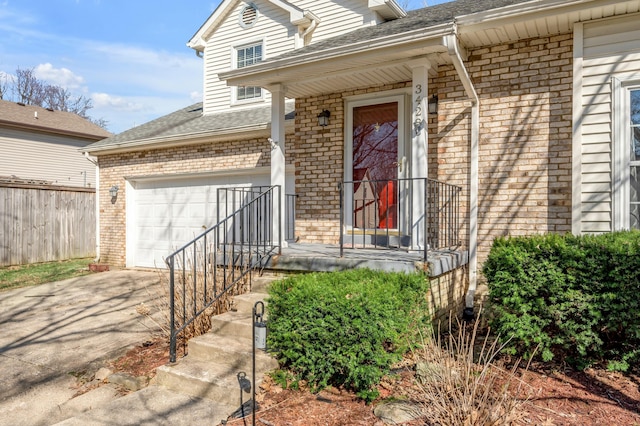 view of exterior entry featuring brick siding, driveway, and a shingled roof