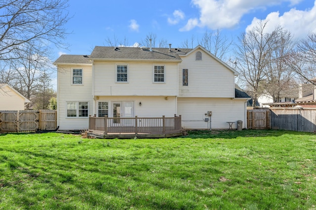 rear view of property featuring a fenced backyard, a deck, and a yard