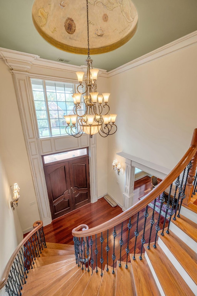 2208 Terranova Ct, Lexington, KY 40513 - entrance foyer with visible vents, crown molding, an inviting chandelier, and wood finished floors