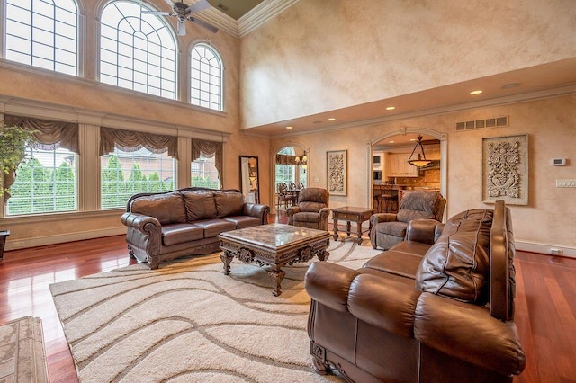 2208 Terranova Ct, Lexington, KY 40513 - living room featuring hardwood / wood-style floors, baseboards, visible vents, arched walkways, and crown molding
