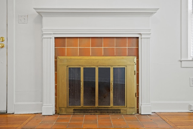 details with a tile fireplace