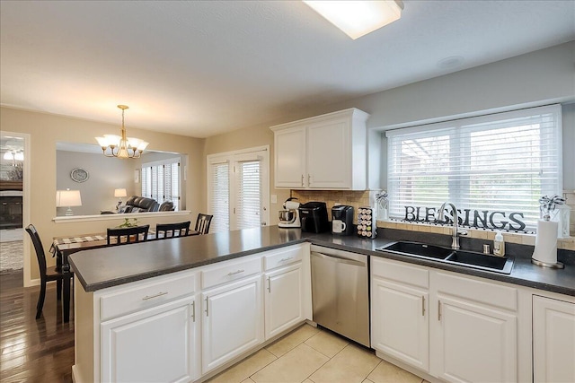 424 Amberley Dr, Lexington, KY 40515 - kitchen featuring a healthy amount of sunlight, a sink, dark countertops, dishwasher, and a peninsula