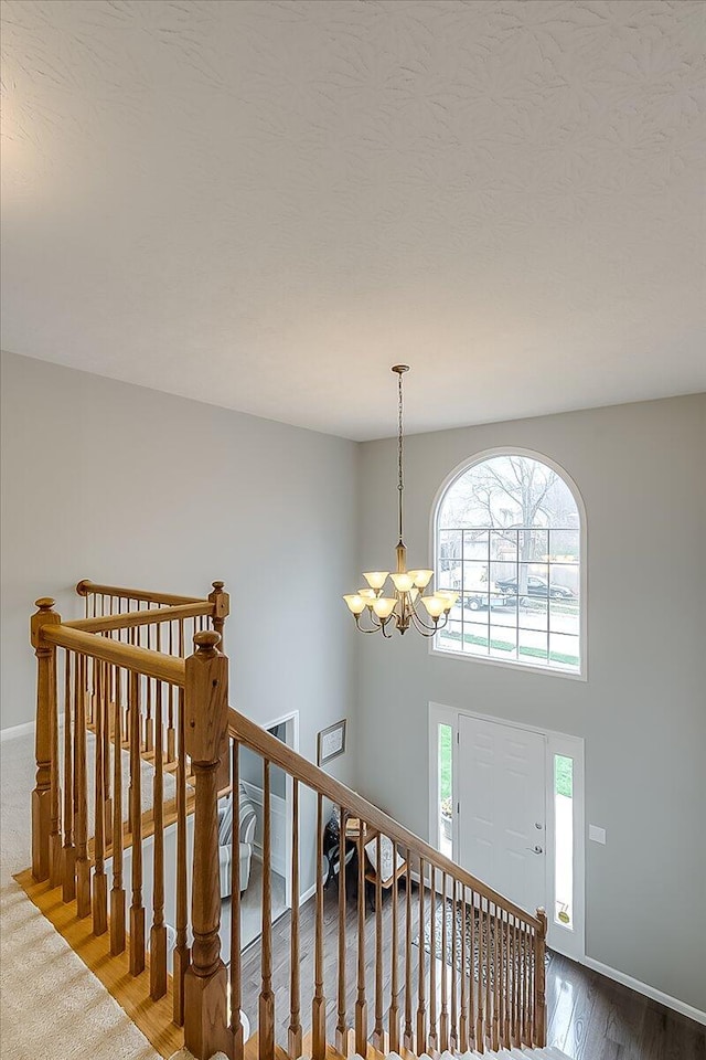 424 Amberley Dr, Lexington, KY 40515 - staircase featuring baseboards, wood finished floors, and an inviting chandelier