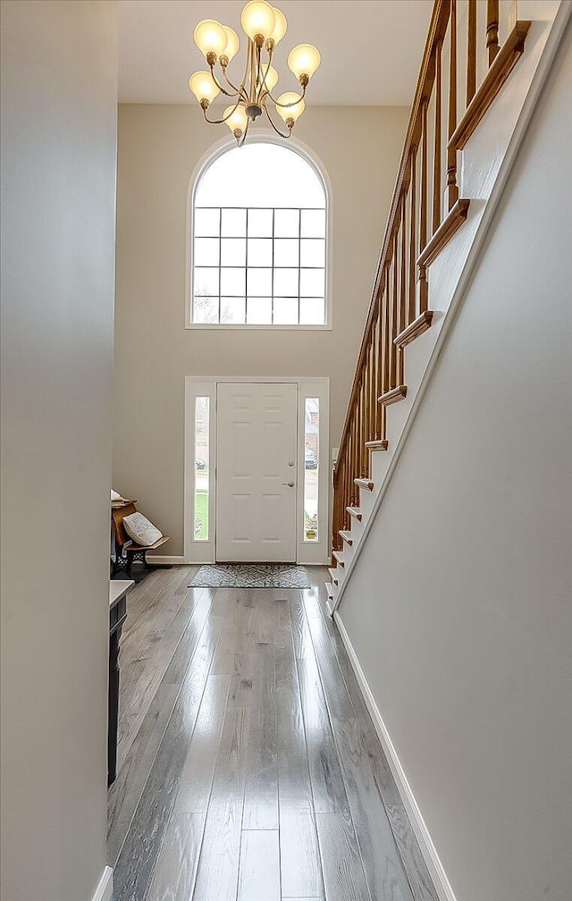 424 Amberley Dr, Lexington, KY 40515 - entrance foyer with baseboards, a towering ceiling, stairway, hardwood / wood-style floors, and an inviting chandelier
