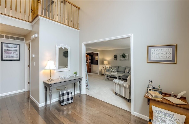 424 Amberley Dr, Lexington, KY 40515 - hall featuring baseboards, visible vents, wood finished floors, and a towering ceiling