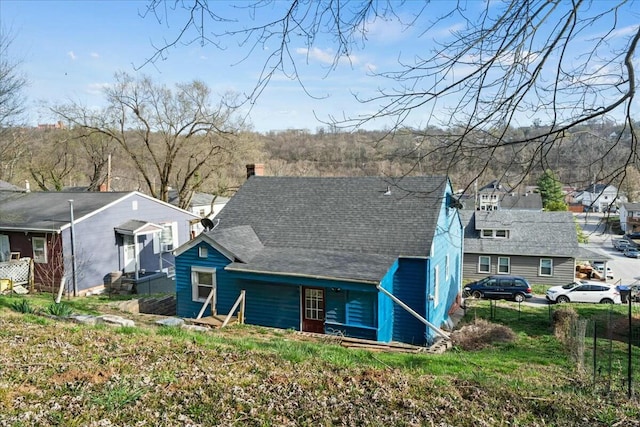 312 Murrell St, Frankfort, KY 40601 - view of front of home with roof with shingles, a chimney, and fence