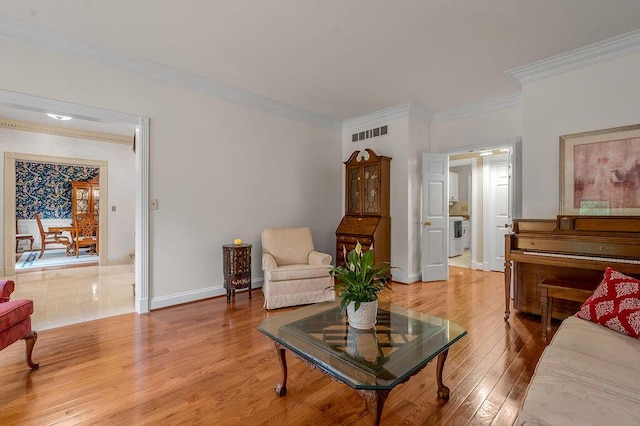 870 Mcmeekin Pl, Lexington, KY 40502 - living area with ornamental molding, light wood-style flooring, washer / dryer, and baseboards