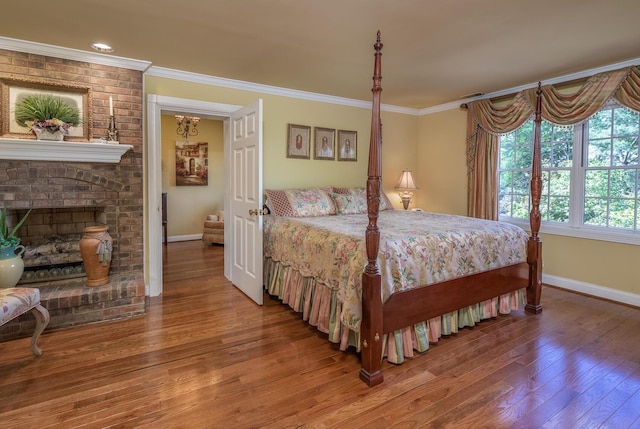 870 Mcmeekin Pl, Lexington, KY 40502 - bedroom featuring baseboards, hardwood / wood-style flooring, crown molding, and a brick fireplace