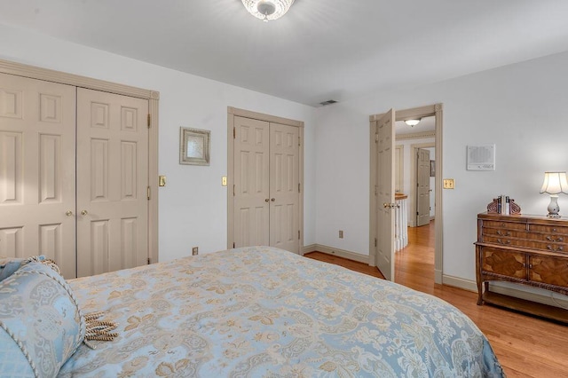 870 Mcmeekin Pl, Lexington, KY 40502 - bedroom featuring two closets, wood finished floors, and baseboards