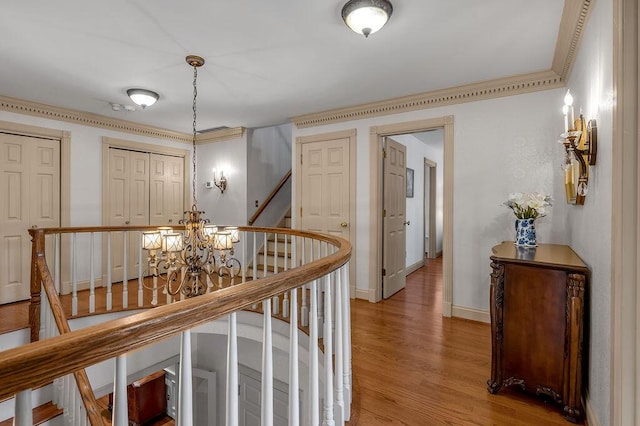 870 Mcmeekin Pl, Lexington, KY 40502 - hallway featuring light wood finished floors, a chandelier, baseboards, and stairs