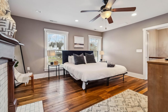 bedroom featuring recessed lighting, wood-type flooring, baseboards, visible vents, and ceiling fan