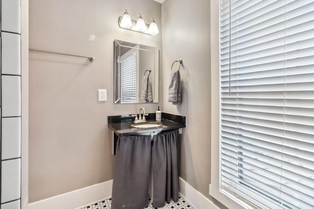 bathroom with baseboards and a sink