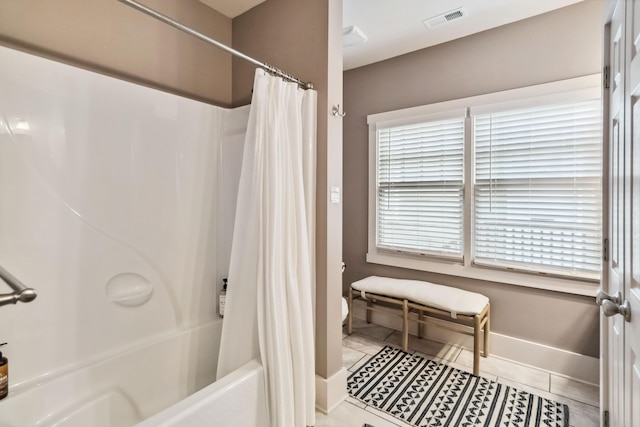 bathroom with toilet, baseboards, tile patterned floors, visible vents, and shower / bath combination with curtain