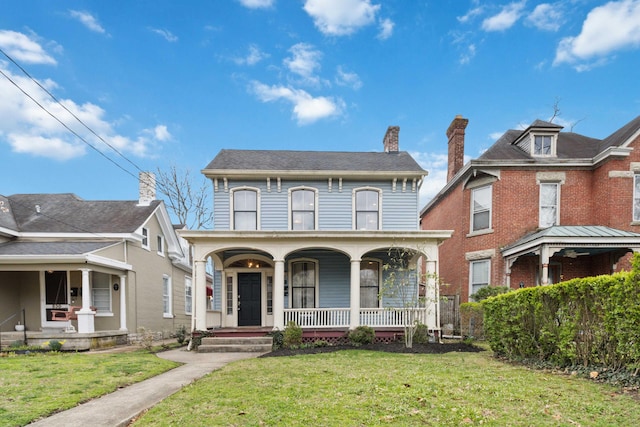 view of front of property with covered porch and a front lawn