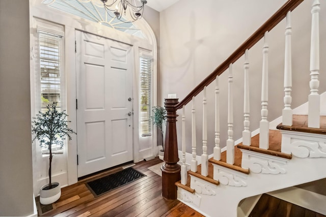 entrance foyer featuring visible vents, stairway, and hardwood / wood-style flooring