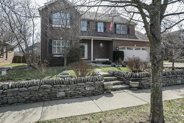 view of front of home featuring a garage, brick siding, and fence